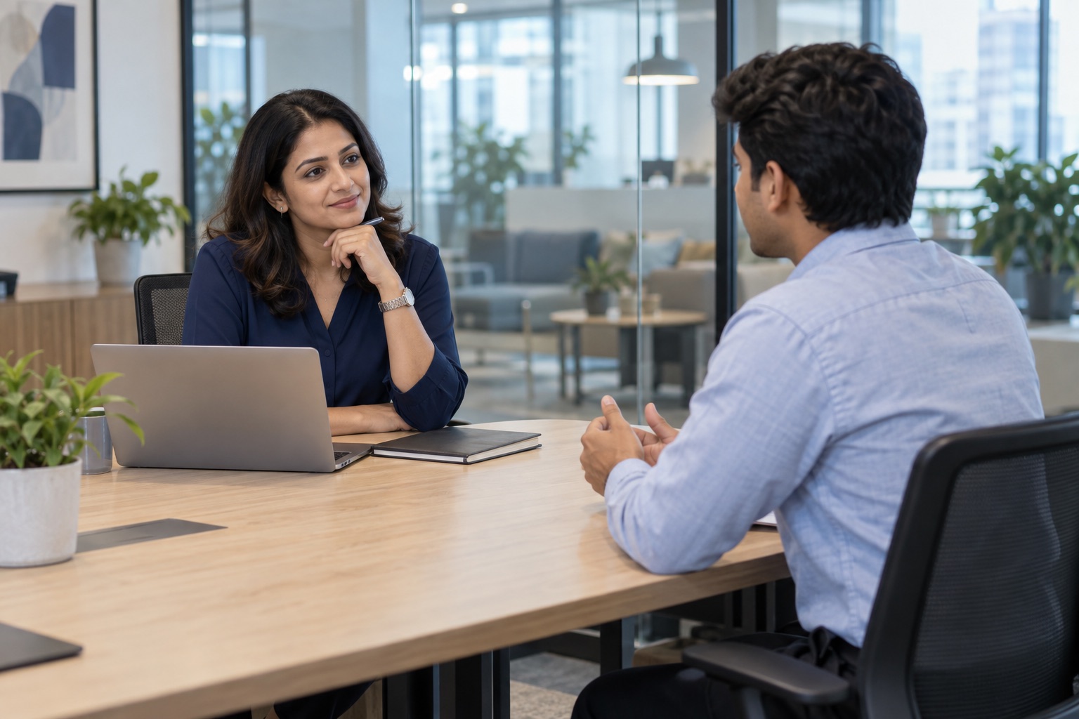 A recruiter listening to a young candidate in an office conversation